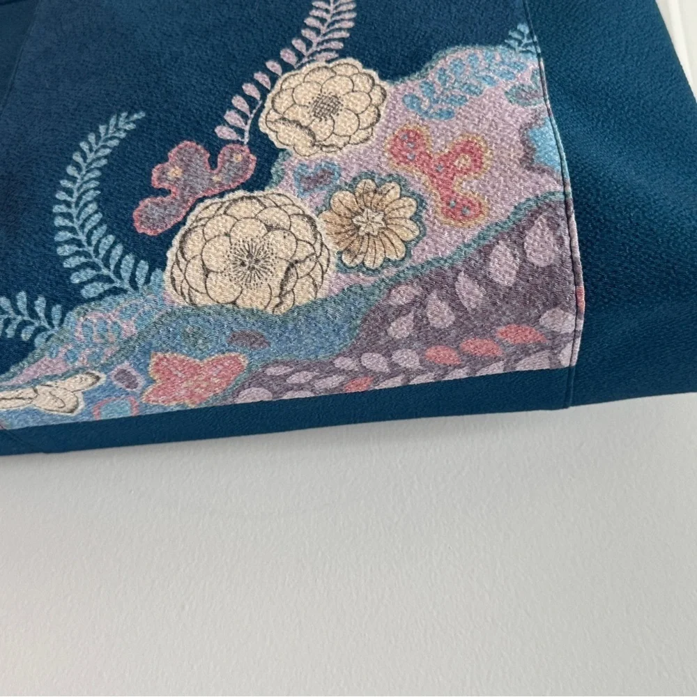 Teal-colored‎ handbag bag featuring intricate floral embroidery